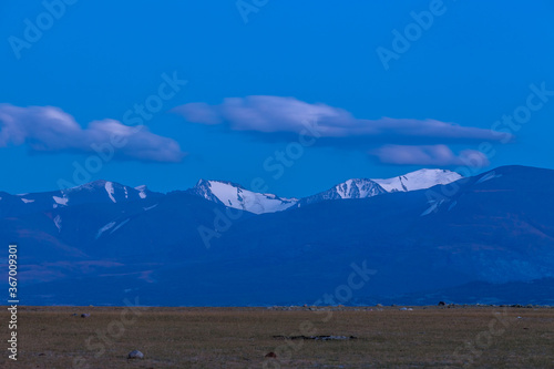 Mountain landscape at sunset. Outstanding view of the mountain ridges and clouds in Altai of Mongolia