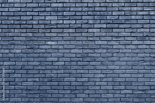 Blue brick wall. Loft interior design. Blue paint of the facade. Architectural background.