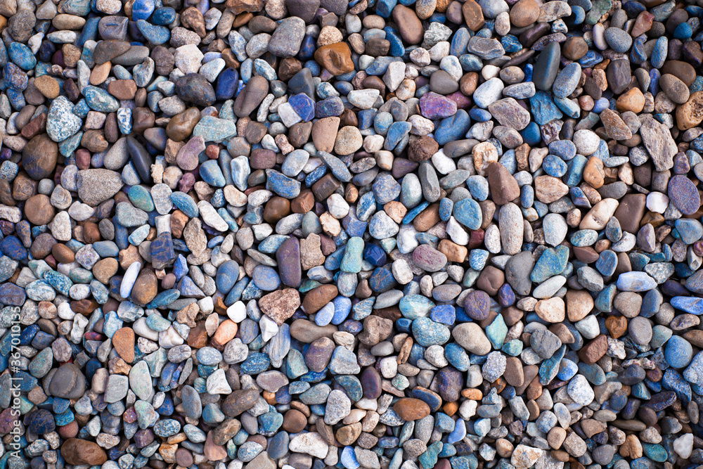 Many multicolor river pebbles as stone texture and background Many multicolor river pebbles as stone texture and background