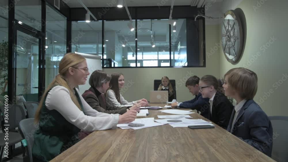 Laughing, cheerful employees gathered in the meeting room. Joy to work. Laughing, cheerful employees gathered in the meeting room. Joy to work.