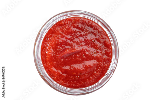 red tomato sauce in a glass bowl isolated on a white background, top view