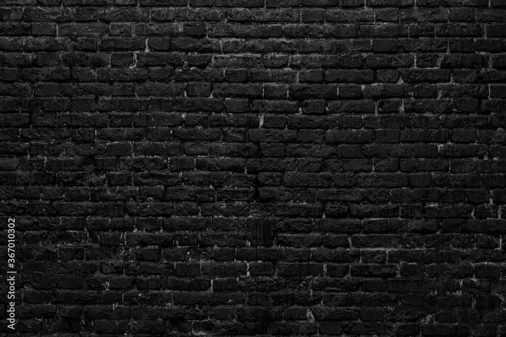 Black brick wall. Loft interior design. Black paint of the facade.