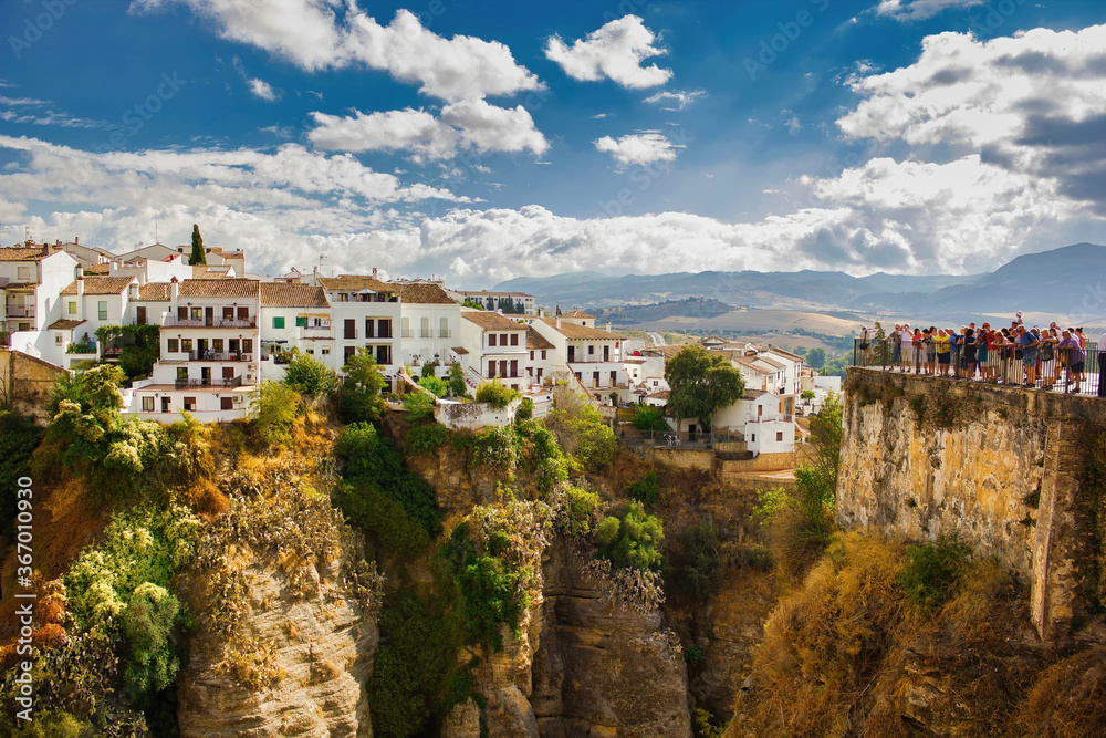 Ronda, Spain - September 06, 2015: Wide angle view of famous Ronda village situated solely on mountaintop against dramatic clouds