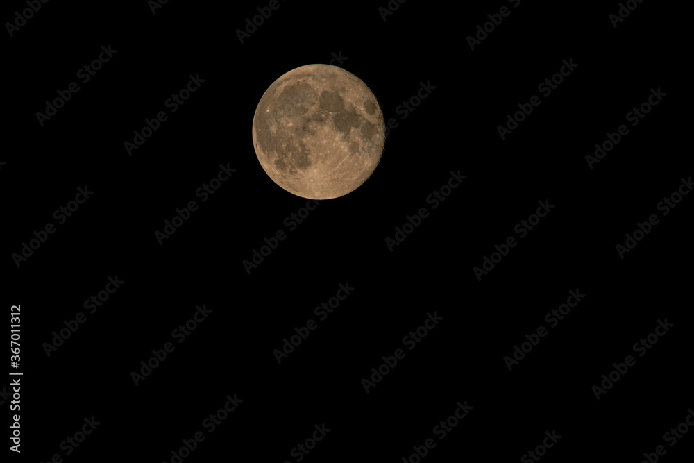 The full moon moves through the night sky The full moon moves through the night sky