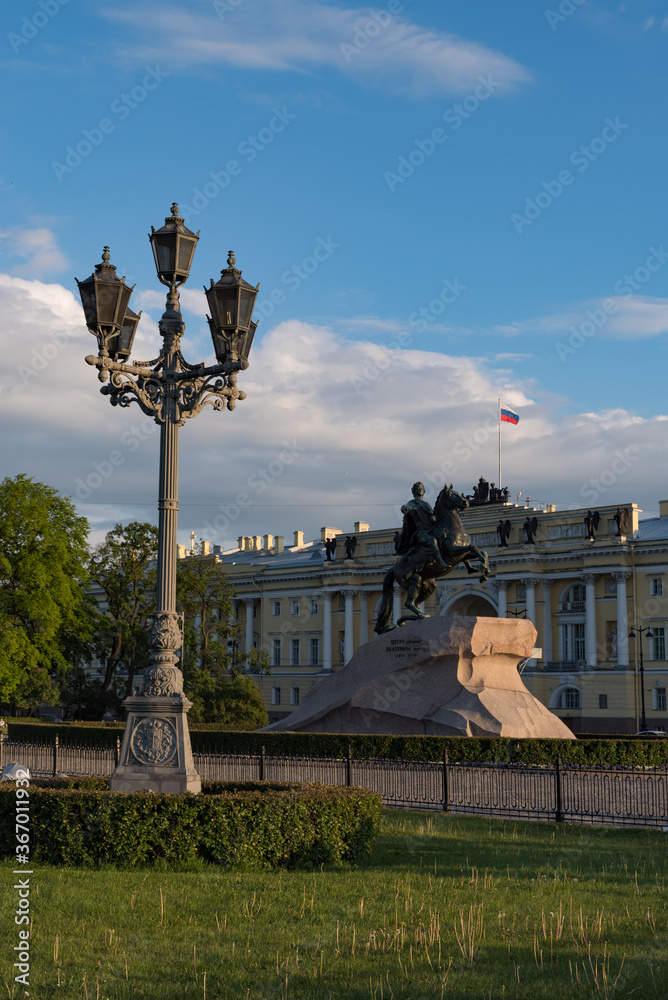 Fototapeta premium The Bronze Horseman is an equestrian statue of Peter the Great in the Senate Square. Building of Constitutional Court of the Russian Federation at the background. Saint Petersburg, Russia