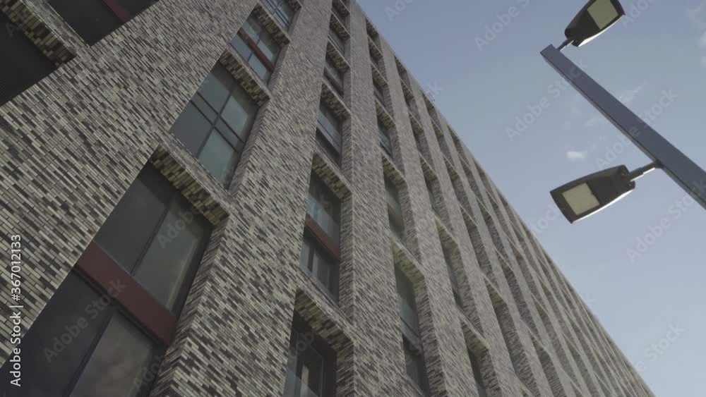 the facade of brick high-rise apartment buildings with stained glass windows. the facade of brick high-rise apartment buildings with stained glass windows.