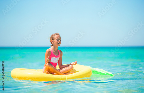 Adorable girl on inflatable air mattress in the sea © travnikovstudio