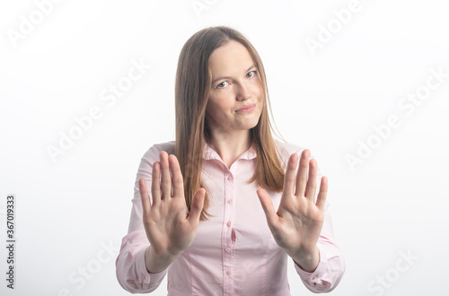 Εκτύπωση καμβά woman gesturing stop or saying no with a smile, with flirt and coquetry, extending her hands palms to camera isolated on white background in pink blouse