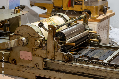 Antique letterpress in use in a print shop