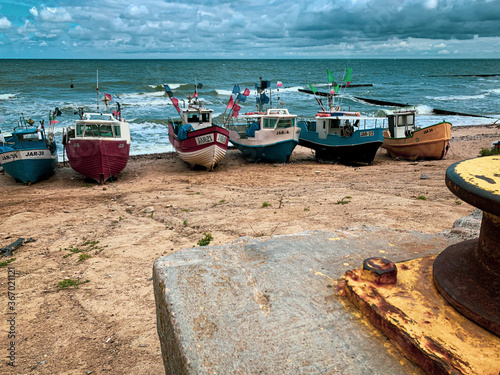 At Beach of Jaroslawiec in Poland fishing boats lie on the beach of the Baltic Sea photo