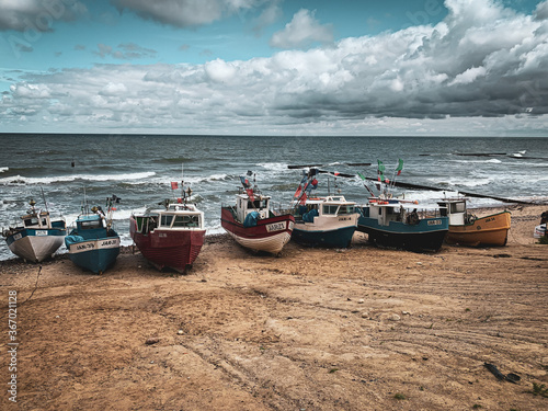 At Beach of Jaroslawiec in Poland fishing boats lie on the beach of the Baltic Sea photo