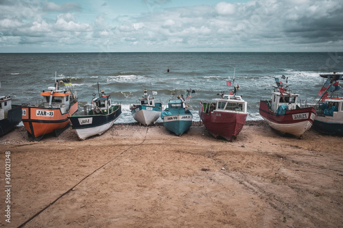 At Beach of Jaroslawiec in Poland fishing boats lie on the beach of the Baltic Sea photo