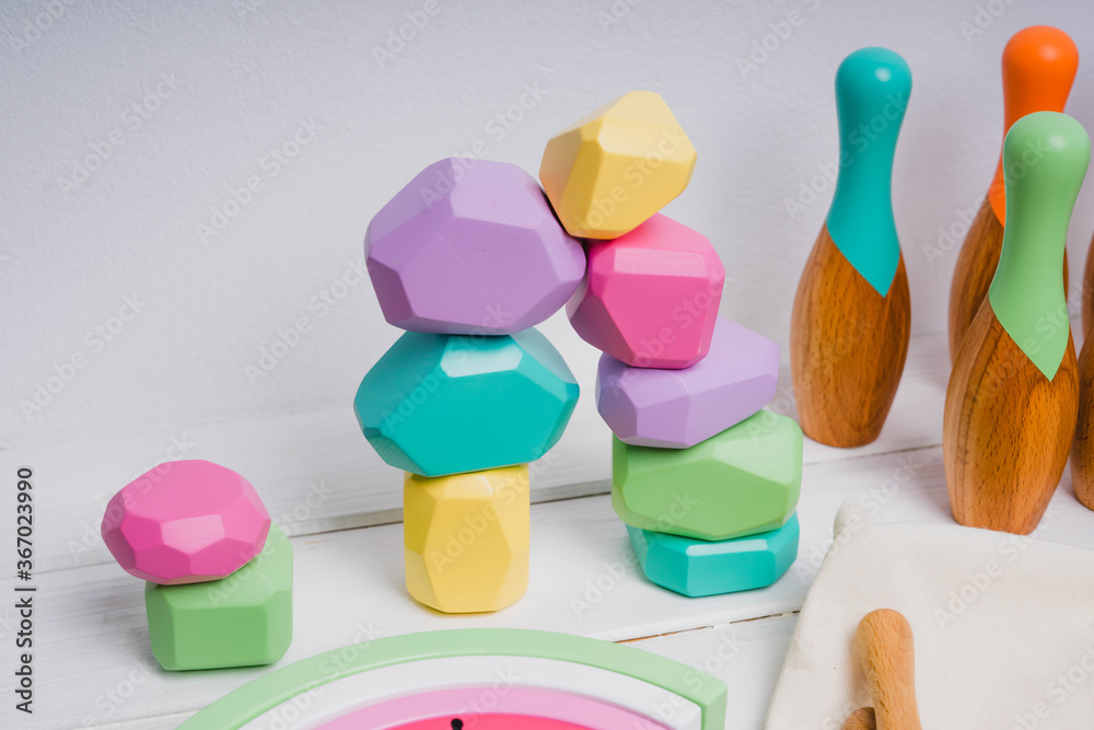 Fototapeta premium Wooden cubes with different faces for the development of coordination and balancing.