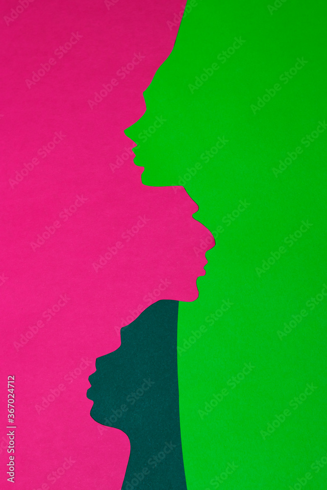 The paper profiles were cut out from pink, navy green and neon green paper. The vertical photo of handmade paper art was shot flat lay for your craft design.