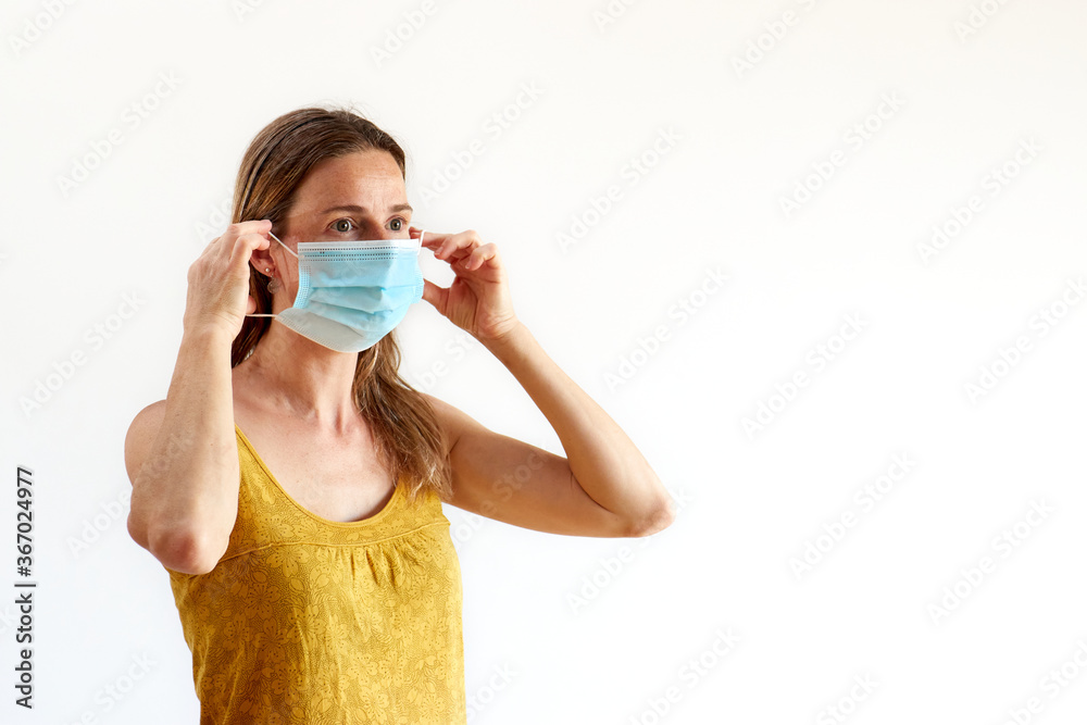 woman putting on her protective mask, white background woman putting on her protective mask, white background