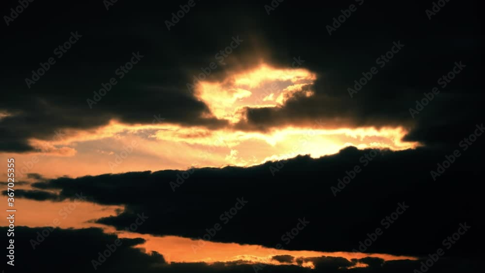 Sunset Cloudy Sky With Fluffy Clouds. Sunset Sky Natural Background With Dark Clouds Sunset Cloudy Sky With Fluffy Clouds. Sunset Sky Natural Background With Dark Clouds