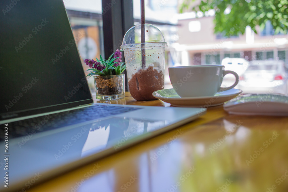 notebook was placed on a table by the window for doing business online at home during the outbreak of the Covid outbreak. notebook was placed on a table by the window for doing business online at home during the outbreak of the Covid outbreak.