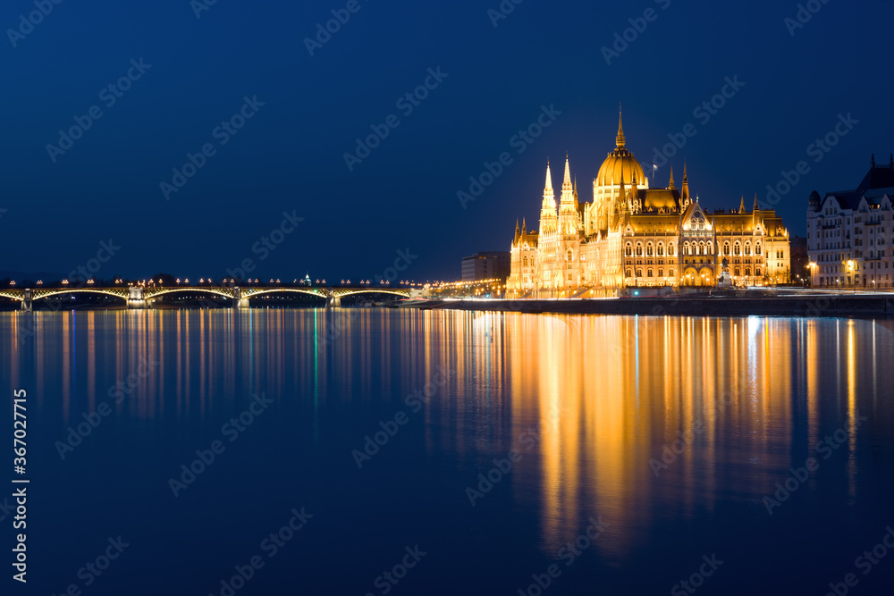 Hungarian Parliament reflecting in water at night