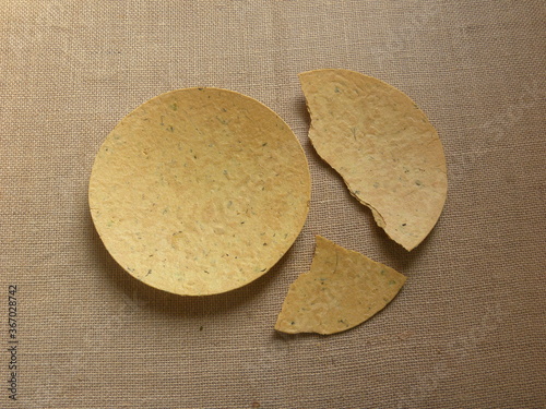 Whole and broken yellow color Khakhra Indian savory snack photo