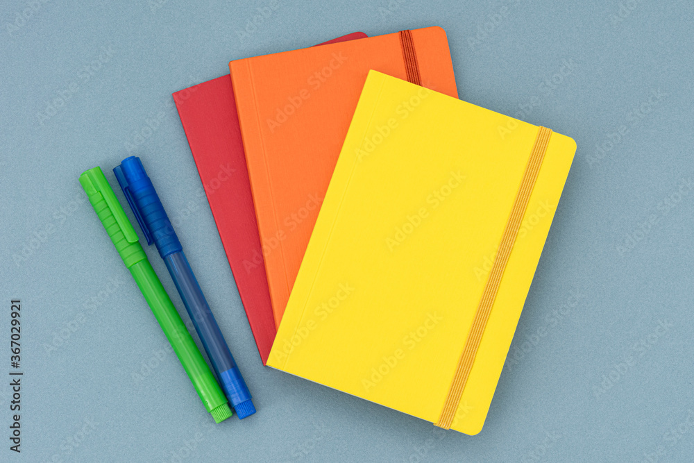 Notepads, eraser and colorful pencils on the blue background. Notepads, eraser and colorful pencils on the blue background.