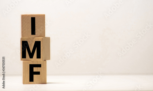 IMF Spelled with Wood Tiles Isolated on a White Background. photo