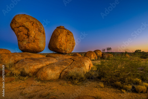 Iconic Devils Marbles: Eggs of mythical Rainbow Serpent on evening twilight sky. Karlu Karlu is one of Australia's most famous natural wonders in Northern Territory, Outback Red Centre. photo