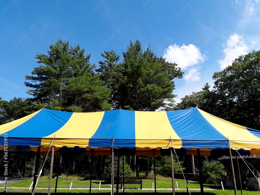 top of a party or events blue and yellow stripe tent