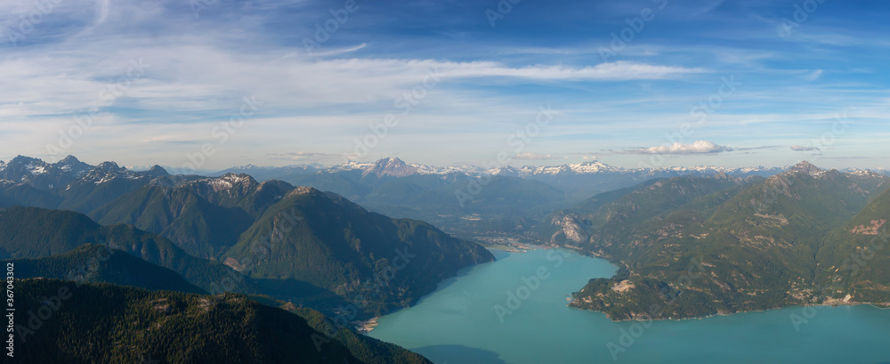 Aerial Panoramic View of Howe Sound, Squamish and Beautiful Canadian Mountain Landscape during sunny and cloudy day. Taken near Vancouver, British Columbia, Canada. Nature Background Panorama
