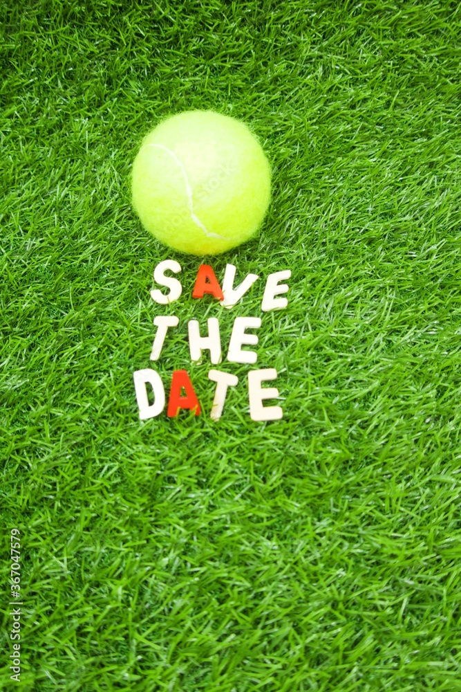Tennis save the date with tennis ball on green grass