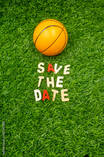 Basketball save the date on green grass background