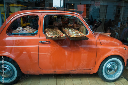 Wallpaper Mural Delicious oven-fired pizza displayed on pizza peels supported by door of red car window.  Torontodigital.ca