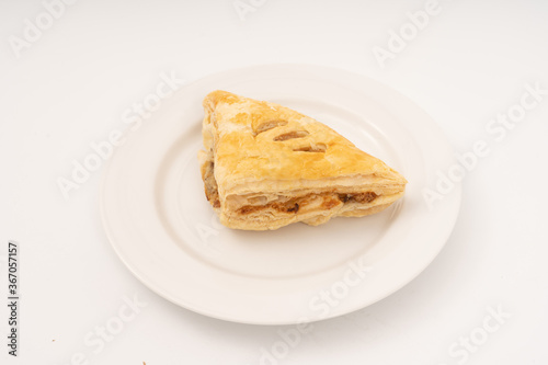 Puff pastry triangles on white background.