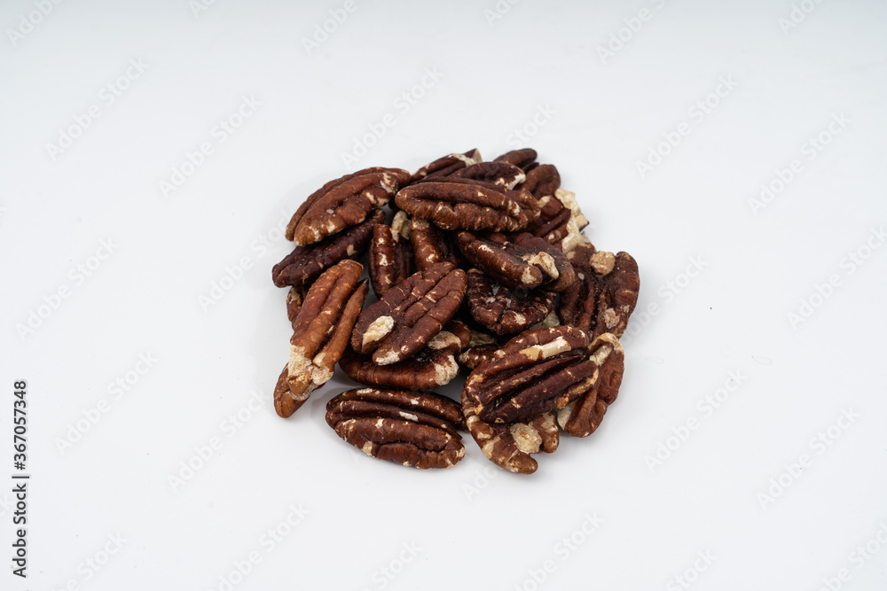 Obraz premium pecan nuts on white background.