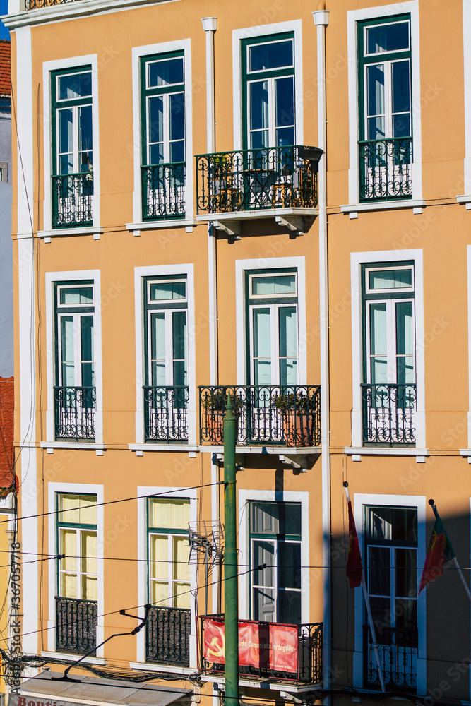 View of classic facade of ancient historical buildings in the downtown area of Lisbon, the hilly coastal capital city of Portugal and one of the oldest cities in Europe