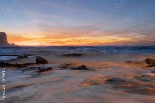 Water flowing around the rocks at dawn. © AlexandraDaryl