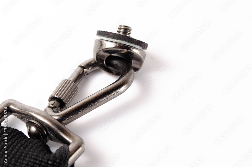 Unloading for the camera on a white background in close-up. Carabiner, hook and screw for attaching the DSLR carrier to the shoulder, chest Unloading for the camera on a white background in close-up. Carabiner, hook and screw for attaching the DSLR carrier to the shoulder, chest