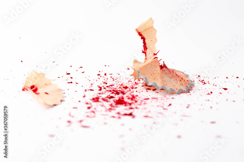 Shavings of red pencil in close-up on a white background. Pencil lead whole and broken on a white background. Leftovers from a pencil. Macro, a pile of shavings