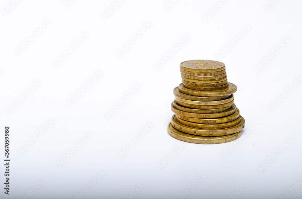 Ukrainian coins on a white background in close-up. Coins in a heap close-up, in the form of a falling pyramid, in a man's hand Ukrainian coins on a white background in close-up. Coins in a heap close-up, in the form of a falling pyramid, in a man's hand