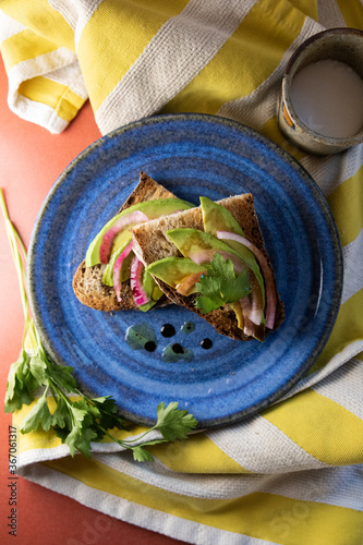 Avocado toast with pickled onions, cilantro and olive oil and vinegar 