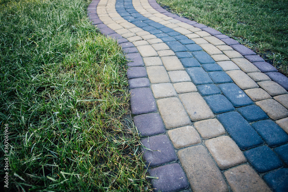 Perspective View Monotone Gray Brick Stone Pavement on The Ground for Street Road. Sidewalk, Driveway, Pavers, green grass