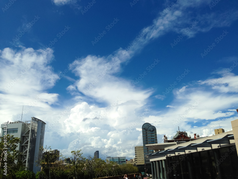 A white cloud and the blue sky which float backed by a city A white cloud and the blue sky which float backed by a city