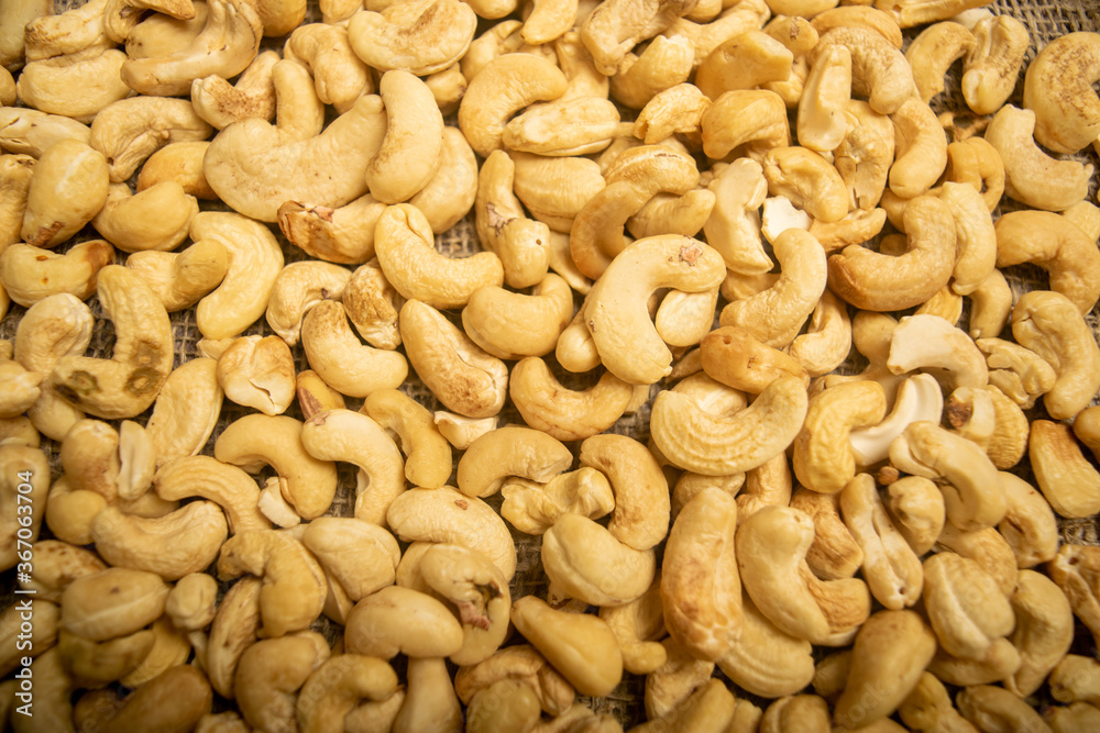 Cashew nuts scattered surface texture. Close up. Cashew nuts scattered surface texture. Close up.