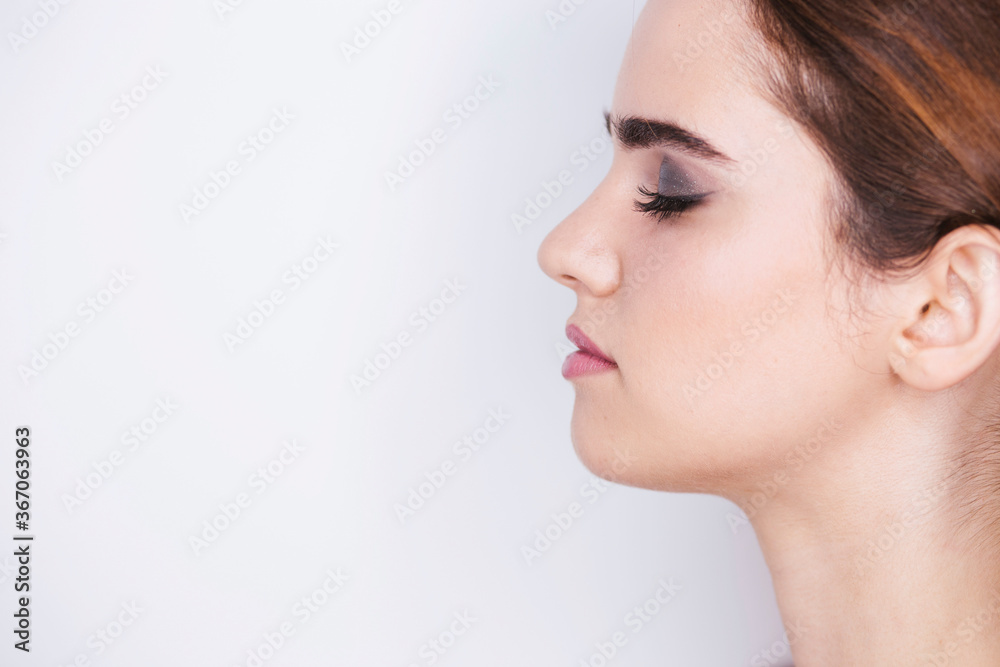 Portrait of a woman with make-up on a white background, make-up concept Portrait of a woman with make-up on a white background, make-up concept