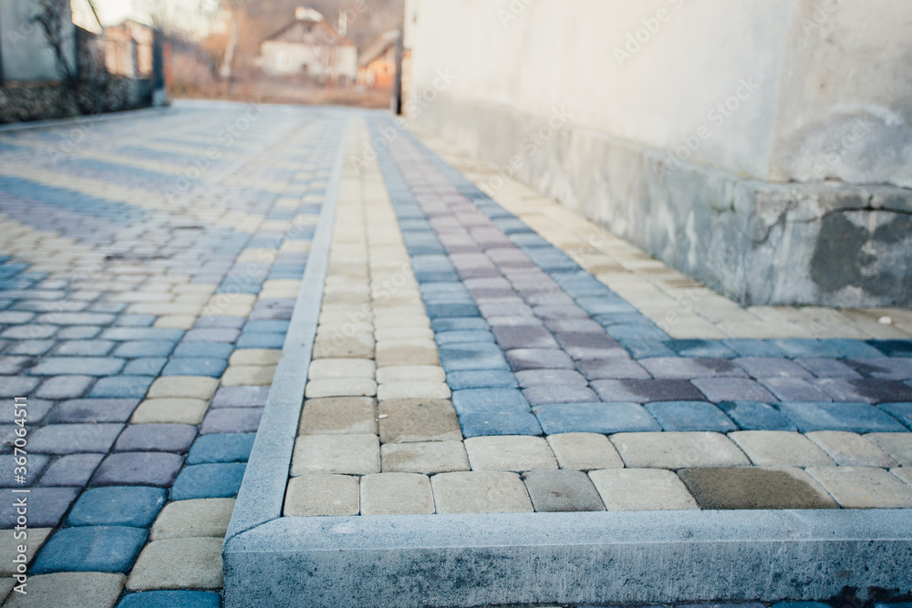 Perspective View Monotone Gray Brick Stone Pavement on The Ground for Street Road. Sidewalk, Driveway, Pavers, green grass