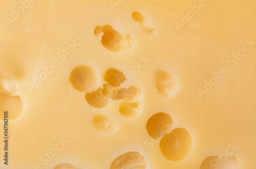 Cheese texture with large holes.