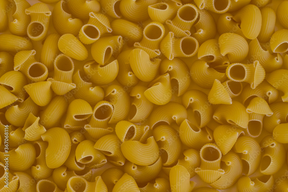 Dry,Uncooked Shape Pasta Background,top view,flat layout. Dry,Uncooked Shape Pasta Background,top view,flat layout.