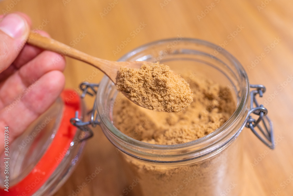 unrefined coconut sugar, natural glucose, glass jar and wooden teaspoon, pure and healthy product, natural molasses unrefined coconut sugar, natural glucose, glass jar and wooden teaspoon, pure and healthy product, natural molasses