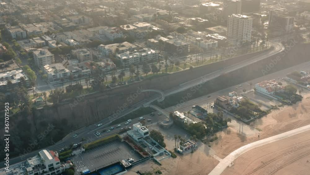COVID-19 pandemic. Empty Santa Monica with no people during quarantine. Flying through clouds at sunrise. Beautiful landscape of city and sand beach in the morning light. 4K aerial view, coronavirus COVID-19 pandemic. Empty Santa Monica with no people during quarantine. Flying through clouds at sunrise. Beautiful landscape of city and sand beach in the morning light. 4K aerial view, coronavirus