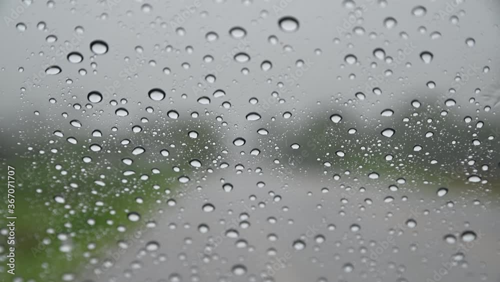 Rain drops on glass car window on the road. Rain drops on glass car window on the road.