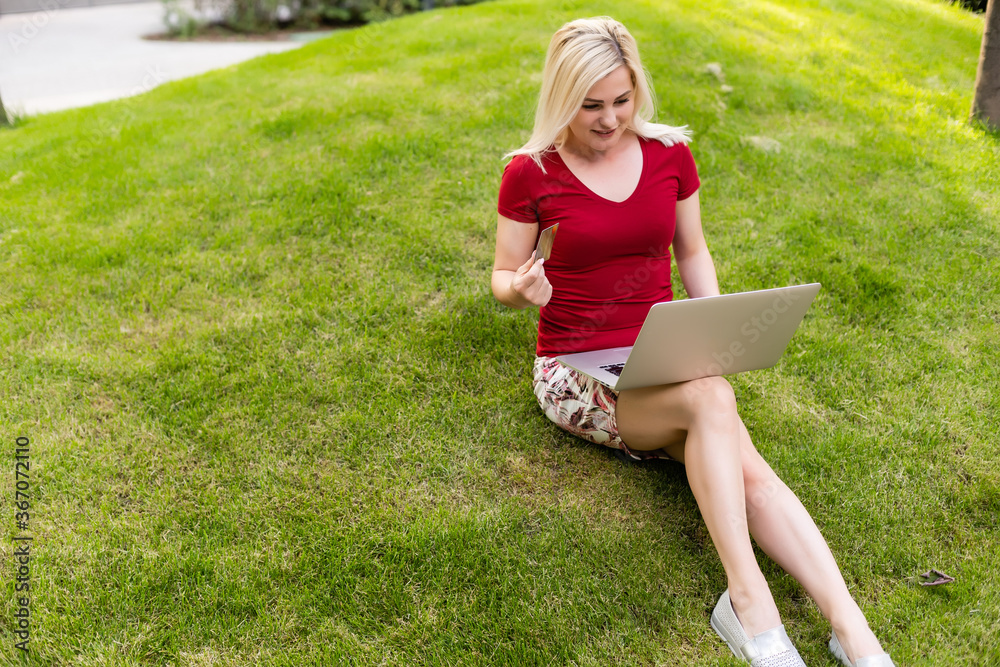 Online payment, woman holding credit card and laptop for online shopping Online payment, woman holding credit card and laptop for online shopping